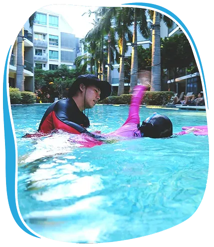 Swimming instructor guiding a child during TWU Effective Swim Program