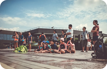 Community group and parents gathering around the pool deck