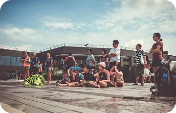 Community group and parents gathering around the pool deck