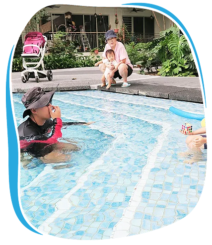 Friendly Dolphin instructor and families enjoying flexible swim lessons at condo pool