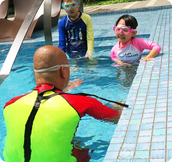 Swimming Instructor Teaching Kids in Pool