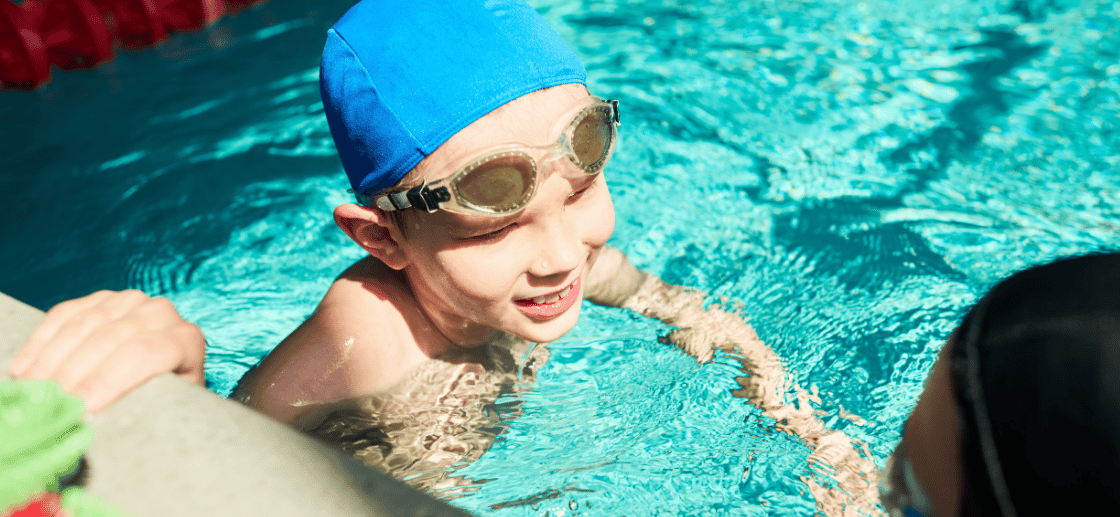 Swimming Instructors Training Students in Pool
